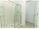 Modern walk-in shower with glass doors and built-in shelving for easy access at 13261 Tropical Breeze Way, Hudson, FL 34669
