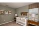Charming Bedroom with a white crib, decorative artwork, and a cozy atmosphere at 13273 Tropical Breeze Way, Hudson, FL 34669