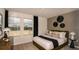 Modern bedroom with large windows, stylish decor, and a comfortable bed with plush pillows at 13273 Tropical Breeze Way, Hudson, FL 34669