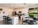 Bright, open kitchen and dining area featuring white cabinets, stainless appliances, and modern finishes at 13273 Tropical Breeze Way, Hudson, FL 34669