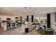 Open-concept living area with kitchen featuring stainless steel appliances and stylish furniture arrangement at 13273 Tropical Breeze Way, Hudson, FL 34669