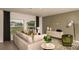 Comfortable living room features a plush sofa, neutral tones, and large windows for natural light at 13273 Tropical Breeze Way, Hudson, FL 34669