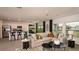 Open-concept living room and kitchen area with modern decor and ample space for entertaining at 13273 Tropical Breeze Way, Hudson, FL 34669