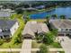 Aerial view of the single-story home, showcasing the community, and backyard pond at 13742 Artesa Bell Dr, Riverview, FL 33579