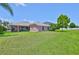 Large backyard with lush lawn, showcasing the home's exterior and outdoor living potential at 13742 Artesa Bell Dr, Riverview, FL 33579