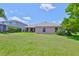 Spacious backyard featuring a well-maintained lawn and view of the home's exterior at 13742 Artesa Bell Dr, Riverview, FL 33579