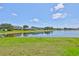Expansive backyard with a tranquil lake view, providing ample space for outdoor activities and relaxation at 13742 Artesa Bell Dr, Riverview, FL 33579