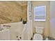 Accessible bathroom features a walk-in tub with safety bars and a window providing natural light at 13742 Artesa Bell Dr, Riverview, FL 33579