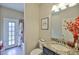 Cozy bathroom offers a bathtub with shower, granite sink vanity, and a door that leads outdoors at 13742 Artesa Bell Dr, Riverview, FL 33579