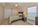 This bedroom features bright walls, a large window, and built-in shelving next to the bed at 13742 Artesa Bell Dr, Riverview, FL 33579