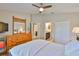 This bedroom features neutral walls, a wooden dresser, and doors that lead to the en-suite bathroom at 13742 Artesa Bell Dr, Riverview, FL 33579