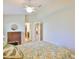 Neutral bedroom features light-colored walls, a ceiling fan, and a glimpse into other parts of the home at 13742 Artesa Bell Dr, Riverview, FL 33579