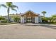 Inviting community entrance with palm trees and well-maintained landscaping for a welcoming feel at 13742 Artesa Bell Dr, Riverview, FL 33579