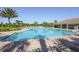 Large community pool with ample lounge chairs and a covered area, perfect for relaxation and recreation at 13742 Artesa Bell Dr, Riverview, FL 33579