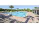 Community pool area with lounge chairs, lush landscaping, and accessible features for all residents at 13742 Artesa Bell Dr, Riverview, FL 33579