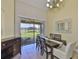Dining room with table, chairs, and sliding glass doors looking out onto the backyard pond at 13742 Artesa Bell Dr, Riverview, FL 33579