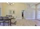 Dining room with dark wood table, light-colored chairs, and tile flooring with decor at 13742 Artesa Bell Dr, Riverview, FL 33579