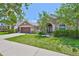 Inviting single-story home with lush green lawn, covered entryway, and attached two-car garage at 13742 Artesa Bell Dr, Riverview, FL 33579