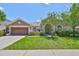 Charming single-story home with a well-maintained lawn and attached two-car garage at 13742 Artesa Bell Dr, Riverview, FL 33579