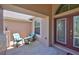 Cozy front porch with two chairs, small table and shade, located by the front door at 13742 Artesa Bell Dr, Riverview, FL 33579