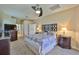 Well-lit main bedroom showcasing ceiling fan and comfortable furnishings at 13742 Artesa Bell Dr, Riverview, FL 33579