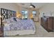 Comfortable main bedroom with ceiling fan, king bed, dresser, and sliding door leading to the outdoors at 13742 Artesa Bell Dr, Riverview, FL 33579