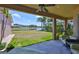 Covered patio overlooking a serene pond, offering a relaxing outdoor living space with lush greenery at 13742 Artesa Bell Dr, Riverview, FL 33579