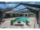 Aerial view of the pool with paved deck and access to the house at 13906 Captains Reef Ct, Tampa, FL 33624