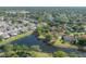 Aerial view showing home with screened pool, and backyard along lake in a quiet neighborhood at 13906 Captains Reef Ct, Tampa, FL 33624