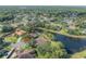An aerial view highlights a property on a circle, complemented by views of lush landscaping and a scenic lake at 13906 Captains Reef Ct, Tampa, FL 33624