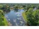 The backyard view includes a large lake, lush trees, and a home situated near the water at 13906 Captains Reef Ct, Tampa, FL 33624