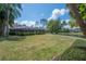 Spacious backyard with a screened patio and mature landscaping, ideal for outdoor living and entertaining at 13906 Captains Reef Ct, Tampa, FL 33624