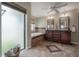 Bathroom featuring a soaking tub, double vanity, and a window, creating a relaxing and spa-like atmosphere at 13906 Captains Reef Ct, Tampa, FL 33624