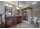 Bathroom featuring double vanities, a glass-enclosed shower, and tiled floors for a luxurious feel at 13906 Captains Reef Ct, Tampa, FL 33624