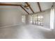 Expansive bedroom with carpet, vaulted ceiling, exposed beams, and patio access, perfect for relaxation at 13906 Captains Reef Ct, Tampa, FL 33624