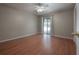 Bright bedroom with hardwood floors, a sliding glass door to the patio, and a ceiling fan at 13906 Captains Reef Ct, Tampa, FL 33624