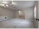 Spacious bedroom with neutral carpet, ceiling fan, and doorway to another room at 13906 Captains Reef Ct, Tampa, FL 33624