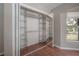 Bedroom closet with shelving and hanging space, mirrored doors, and a window at 13906 Captains Reef Ct, Tampa, FL 33624