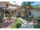 Close-up of the home's entrance with stone pillars and manicured landscaping, enhancing curb appeal at 13906 Captains Reef Ct, Tampa, FL 33624