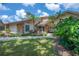 Charming front exterior with well-manicured lawn, stone accents, and lush greenery offering a warm welcome at 13906 Captains Reef Ct, Tampa, FL 33624
