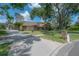 Stunning exterior view of the stone-accented home with mature landscaping and a concrete driveway at 13906 Captains Reef Ct, Tampa, FL 33624