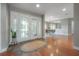 Elegant foyer featuring double doors, hardwood floors, and a view into the dining area, creating a welcoming ambiance at 13906 Captains Reef Ct, Tampa, FL 33624
