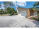 Side view of the two-car garage with ample parking on the large concrete driveway at 13906 Captains Reef Ct, Tampa, FL 33624