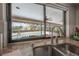 Kitchen sink and countertop overlooking the screened pool area through a large window, offering a bright, open view at 13906 Captains Reef Ct, Tampa, FL 33624