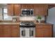 Close-up of updated kitchen gas range and stainless steel microwave complemented by ample cabinet and countertop space at 13906 Captains Reef Ct, Tampa, FL 33624