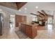 Open concept kitchen with large island, granite countertops, and views of the living room featuring a stone fireplace at 13906 Captains Reef Ct, Tampa, FL 33624