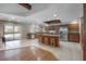 Spacious kitchen featuring a large island with bar stools, stainless steel appliances, and sliding door to the pool at 13906 Captains Reef Ct, Tampa, FL 33624