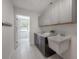 Well-lit laundry room with ample storage, modern cabinets, and a utility sink at 13906 Captains Reef Ct, Tampa, FL 33624