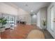 Open-concept living room boasts wood floors, vaulted ceilings, and abundant natural light from sliding glass doors at 13906 Captains Reef Ct, Tampa, FL 33624