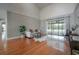 Spacious living room with soaring ceilings, wood flooring, modern decor, and sliding glass doors to the outdoors at 13906 Captains Reef Ct, Tampa, FL 33624